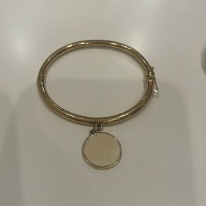 Kate Spade gold bracelet with cream colored charm “the creme de La creme.”
